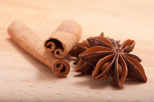 Cinnamon sticks and anise on a breadboard