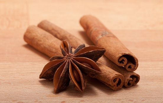 Cinnamon sticks and anise on a breadboard