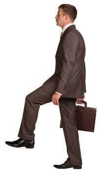 Walking businessman with briefcase. Isolated on the white background.