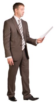 Standing businessman looking at paper sheet. Isolated on the white background.