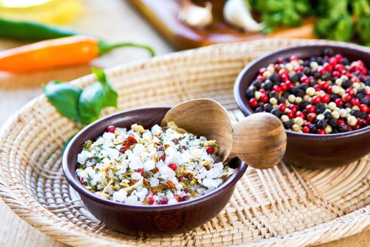 Sea salt with herbs and spices in a wood bowl