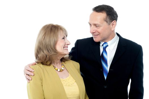 Smiling aged couple embracing each other