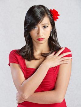 Beautiful young Asian woman with red flower in hair