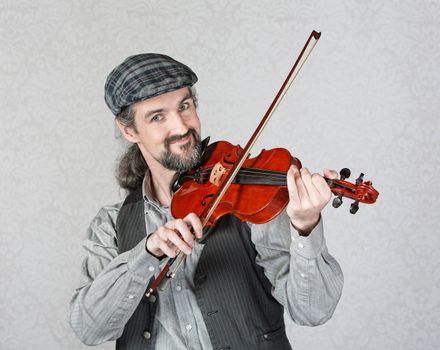 Single Irish fiddler in beard playing instrument