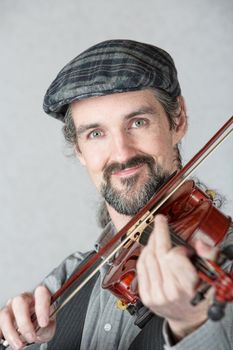 Close up of cute Irish fiddler with instrument
