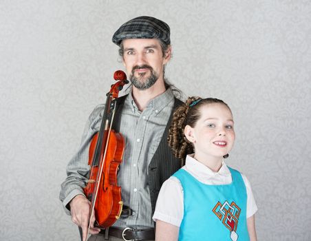 Irish folk music parent holding violin with cute child 
