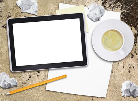 Tablet pc and coffee cup on old concrete surface. Computer technology concept