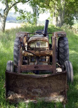 an old rusty tractor on a farm