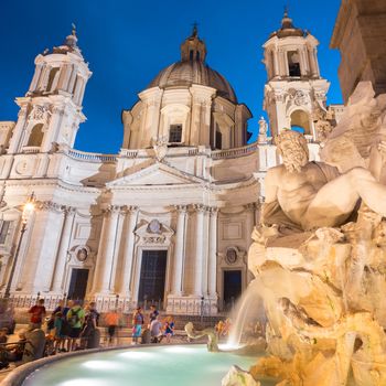 Fountain of the four Rivers and SantAgnese in Agone on Navona square in Rome, Italy, Europe shot at dusk.