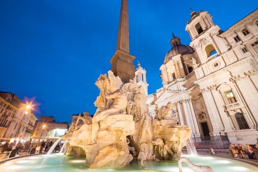 Fountain of the four Rivers and SantAgnese in Agone on Navona square in Rome, Italy, Europe shot at dusk.