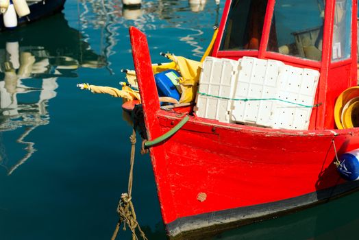 Red small fishing boat with fishing equipment docked in port - Lerici, La Spezia, Liguria, Italy