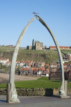 Whalebone arch in Whitby, North Yorkshire, constructed from two jaw bones to commemorate whaling in the region framing the ruins of Whitby Abbey on Tate Hill