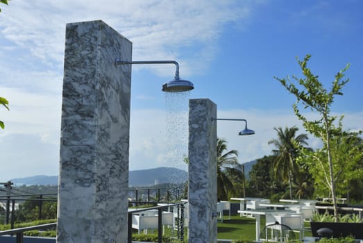 Outdoor shower at swimming pool and beach. The place you get clean after a nice day on the beach.
