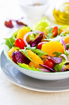 Orange with rocket and lettuce salad in a bowl,