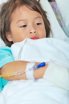 Sick little girl in hospital bed