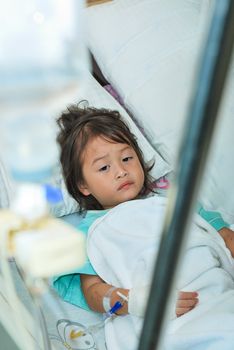 Sick little girl in hospital bed