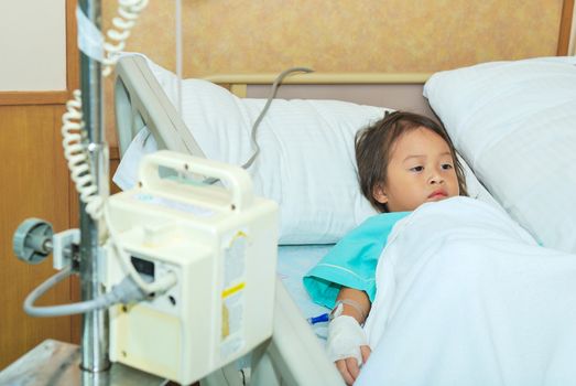 Sick little girl in hospital bed