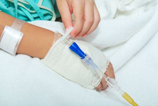 Hand of sick little girl at hospital