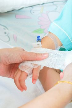 Hand of sick little girl at hospital