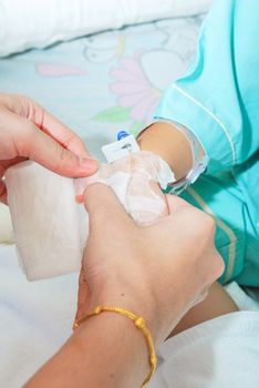 Hand of sick little girl at hospital