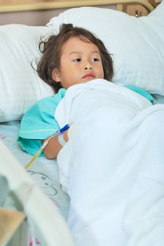 Sick little girl in hospital bed