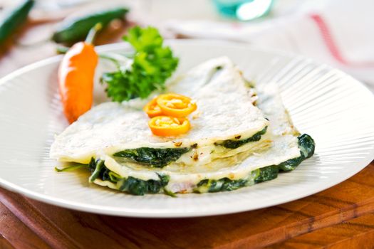 Spinach and cheese Quesadilla with chili on top