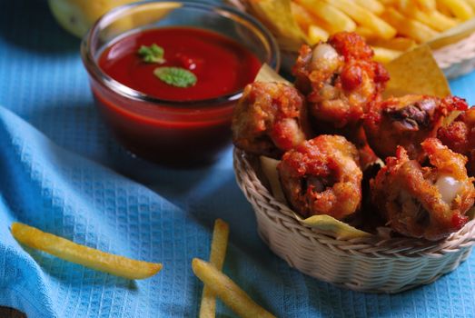 fried chicken wings with french fries and ketchup