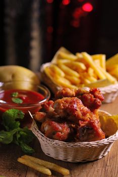 fried chicken wings with french fries and ketchup