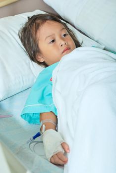 Sick little girl in hospital bed