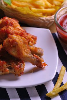 fried chicken wings with french fries and ketchup