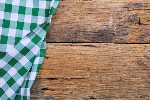 the background made from checkered napkin on old wooden table