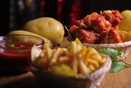 fried chicken wings with french fries and ketchup