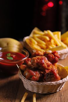 fried chicken wings with french fries and ketchup