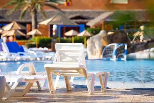 sun loungers on swimming pool with nobody in tunisian ressort Borj Cedria, Caribbean World