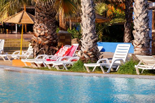 sun loungers on swimming pool with nobody in tunisian ressort Borj Cedria, Caribbean World