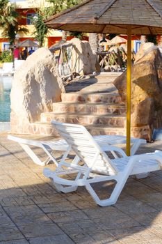 sun loungers on swimming pool with nobody in tunisian ressort Borj Cedria, Caribbean World