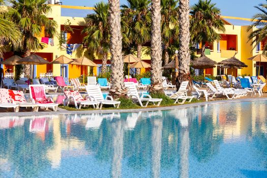 sun loungers on swimming pool with nobody in tunisian ressort Borj Cedria, Caribbean World