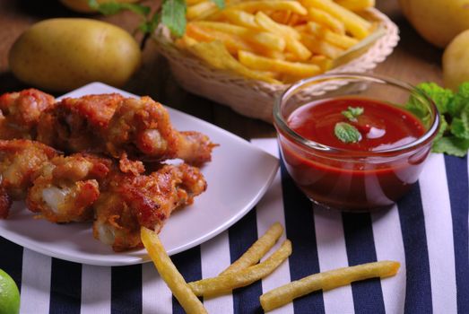 fried chicken wings with french fries and ketchup