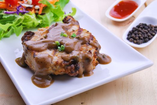 Grilled steaks, pork with pepper gravy and vegetable salad