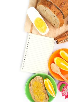 Recipe book with wholegrain bread and orange jam