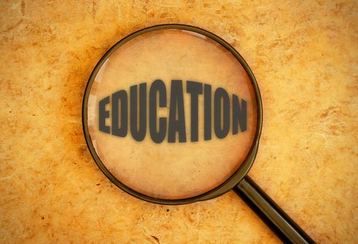 Magnifying glass focusing on the text heading education 