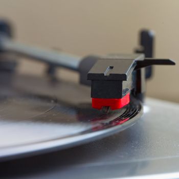 Turntable with a vinyl record, square image