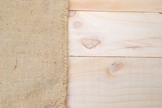 Gunny sack texture and wood plank table background