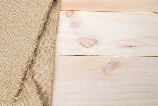 Gunny sack texture and wood plank table background