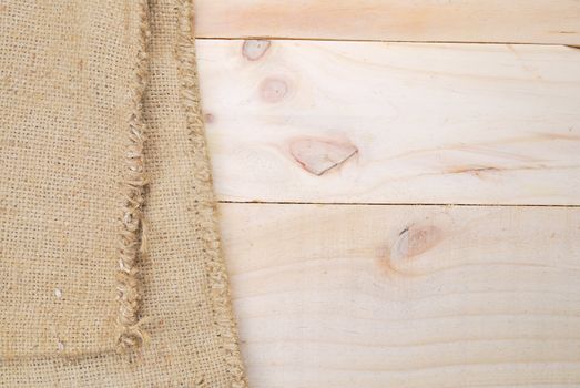 Gunny sack texture and wood plank table background