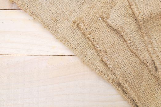 Gunny sack texture and wood plank table background