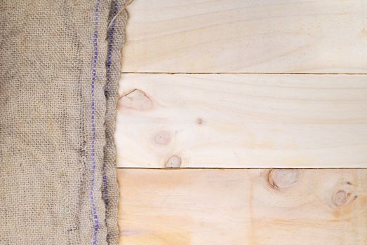 Gunny sack texture and wood plank table background