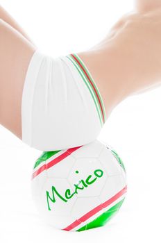 RIO DE JANEIRO, BRAZIL – DECEMBER 17, 2010: Photo of a  fitness model holding a sports ball from the Mexican soccer team.