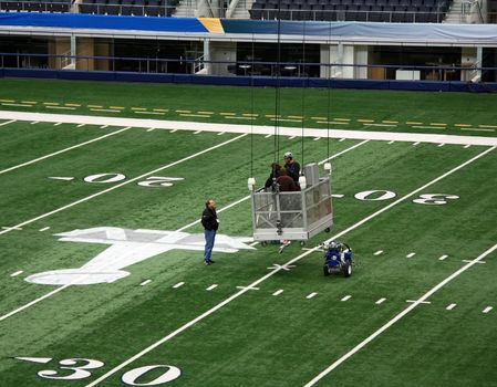 ARLINGTON - JAN 26: Unidentified workers prepare the field in Cowboys Stadium in Arlington, Texas for Super Bowl XLV. Taken January 26, 2011 in Arlington, TX.