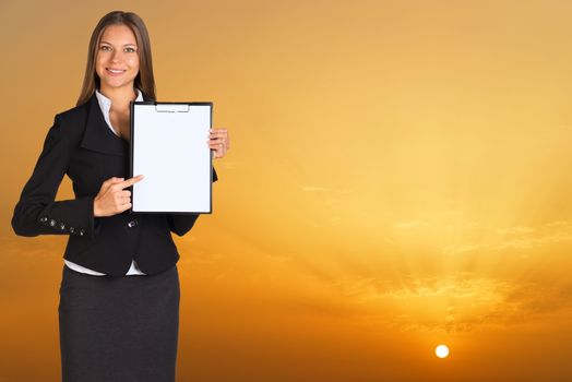 Businesswoman holding paper holder. Magic orange sunset as backdrop